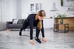 Image of woman workout at home, stretching her head and neck, does warm-up  Stock Image #250193146