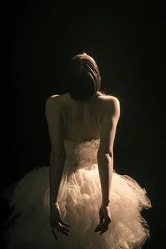 Young beautiful ballet dancer is posing in studio, view back. Stock Photos