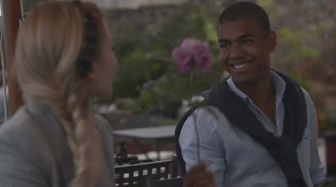 Young beautiful black man present a rose to a beautiful blonde woman 動画素材 64517688