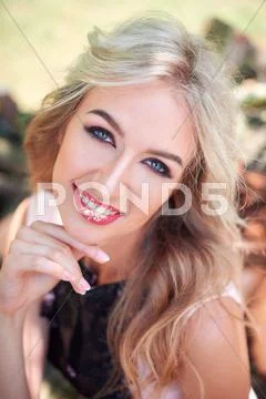 Young beautiful blonde girl in a park Stock Photos