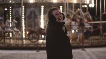 Young beautiful blonde having fun in amusement park at night in winter Stock Footage 85709565