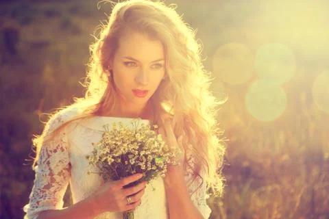 Young Beautiful Bride Outdoors at Sunset Stock Photos