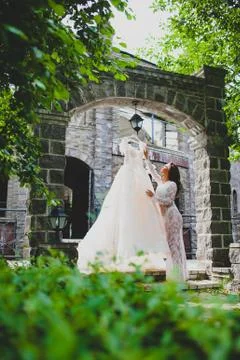 Young beautiful bride preparing to try on her luxury bridal dress Foto stock