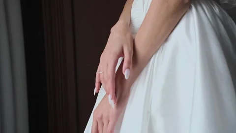 A young beautiful bride strokes herself with her hand Stock Footage 328314860