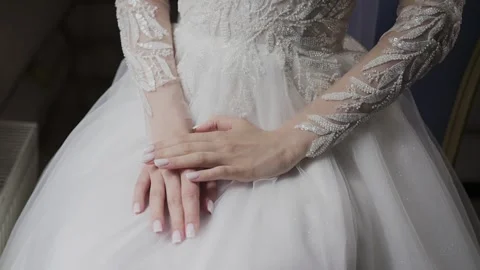 A young beautiful bride strokes herself with her hand Stock Footage 328314926