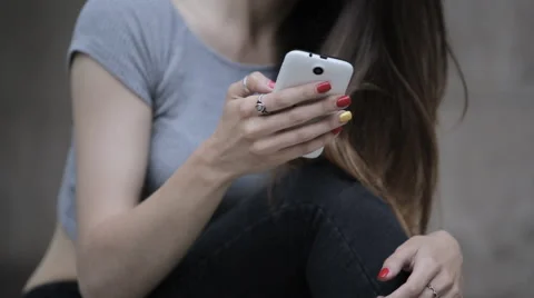 Young beautiful brunette typing a message on a smartphone Stock Footage 63911428