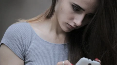 Young beautiful brunette typing a message on a smartphone Stock Footage 63911434