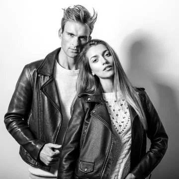 Young beautiful couple in black leather jackets. Black-white portrait. Stock Photos