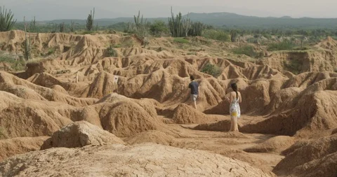 Young, beautiful couple exploring scenic desert hiking trail Stock Footage 86100889