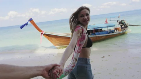 Young beautiful couple holding hands woman leading boyfriend to travel on an aut Stock Footage 201095937