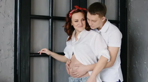 Young beautiful couple look to the side. Stand amid front of his house. Stock Footage 61709647