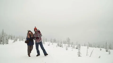 Young beautiful couple posing over winter forest. Outdoor winter portrait over Stock Footage 73463152