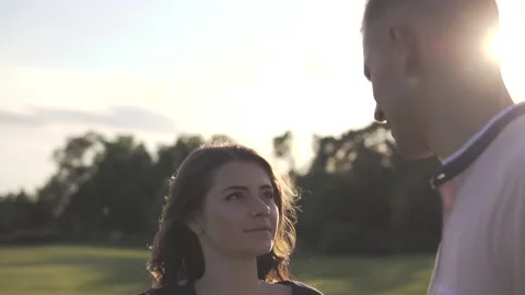 Young beautiful couple on sunset background Stock Footage 112247806