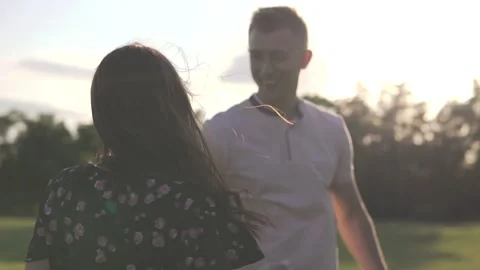 Young beautiful couple on sunset background Stock Footage 112247872