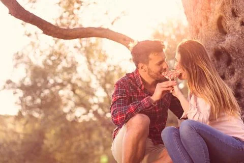 Young beautiful couple under tree in beautiful nature. Stock Photos