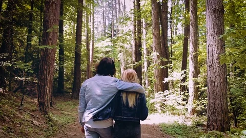 Young Beautiful Couple Walking Through Forest Stock Footage 89894146