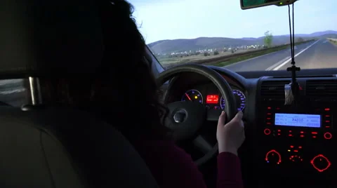 Young beautiful curly haired hispanic woman driving car - rear view Stock Footage 62874681