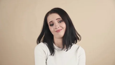 A young beautiful cute brunette oops, Oh, accidentally, not guilty  emotions Stock Footage 85279036