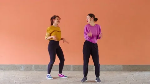 Young beautiful dancers perform dance steps in perfect synchrony  Stock Footage 154113860