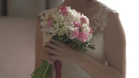 Young beautiful dark-haired bride with bouquet of tulips and freesias Stock Footage 94210997