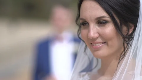 Young beautiful dark-haired bride smiling background of the groom	 Stock Footage 94212940
