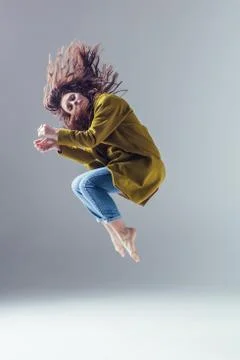 Young beautiful female dancer is posing in the studio Stock Photos