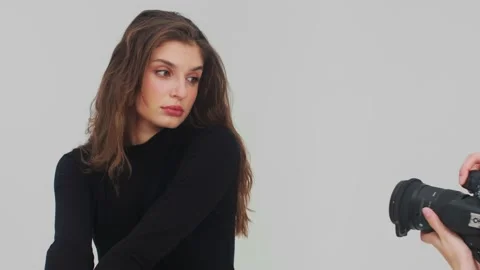 Young beautiful female model posing for a professional photographer during a Stock Footage 238771956