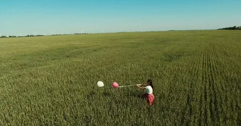 Young beautiful girl with baloons Stock Footage