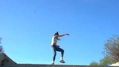 Young beautiful girl dancing in a park Stock Footage