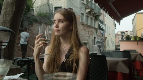 Young Beautiful Girl Drinks Wine in The Cafe of Venice Stock Footage