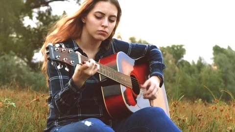 A young beautiful girl, embraced by a creative endeavor and inspired by a forest Stock Footage