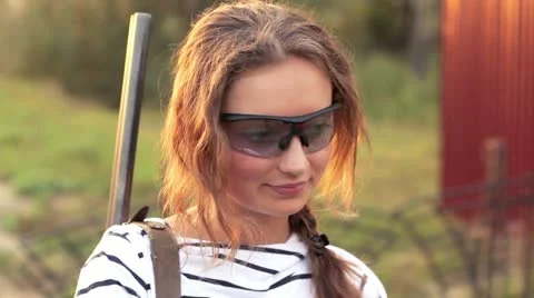Young beautiful girl in glasses with a gun shooting Stock Footage