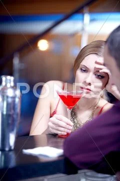 Young beautiful girl grieving at bar Stock Photos