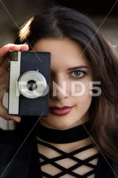 Young beautiful girl holding a camera Stock Photos