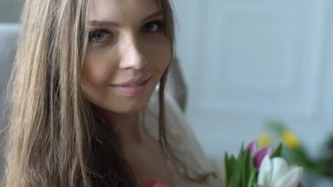 A young beautiful girl posing on a camera with flowers Stock-Footage 88779614