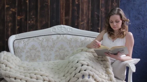 Young beautiful girl reading a book Stock Footage