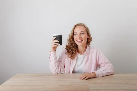 Young beautiful girl student drinks morning coffee Stock Photos
