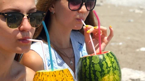 Young beautiful girls in sunglasses drinking fresh fruit cocktails Stock Footage