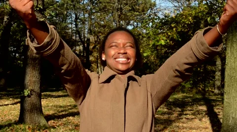 Young beautiful happy african girl rejoices and stands in the woods Video stock 59797874