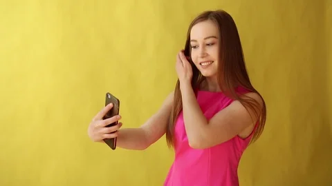 Young beautiful lady standing isolated over yellow background while make selfie Stock Footage 90239705
