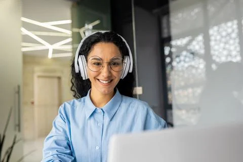 Young beautiful latin american programmer working inside office with laptop Stock Photos