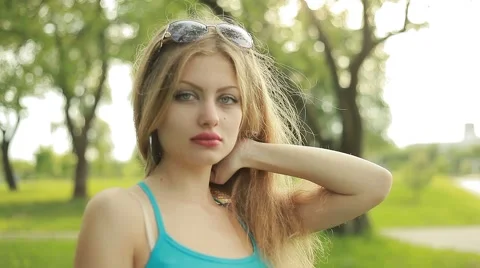Young beautiful long-haired blonde in the summer on the nature Stock Footage 59916023