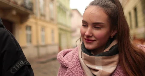 A young, beautiful, loving couple walking on a gloomy autumn day Stock Footage 247487162
