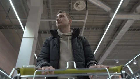 Young beautiful man walks through the supermarket. view from shopping cart Stock Footage 102349102