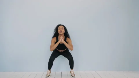 Young beautiful model doing squats Stock Footage 161319145