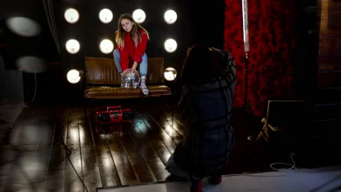 Young beautiful model posing for the photographer in the studio Stock Footage 144692123