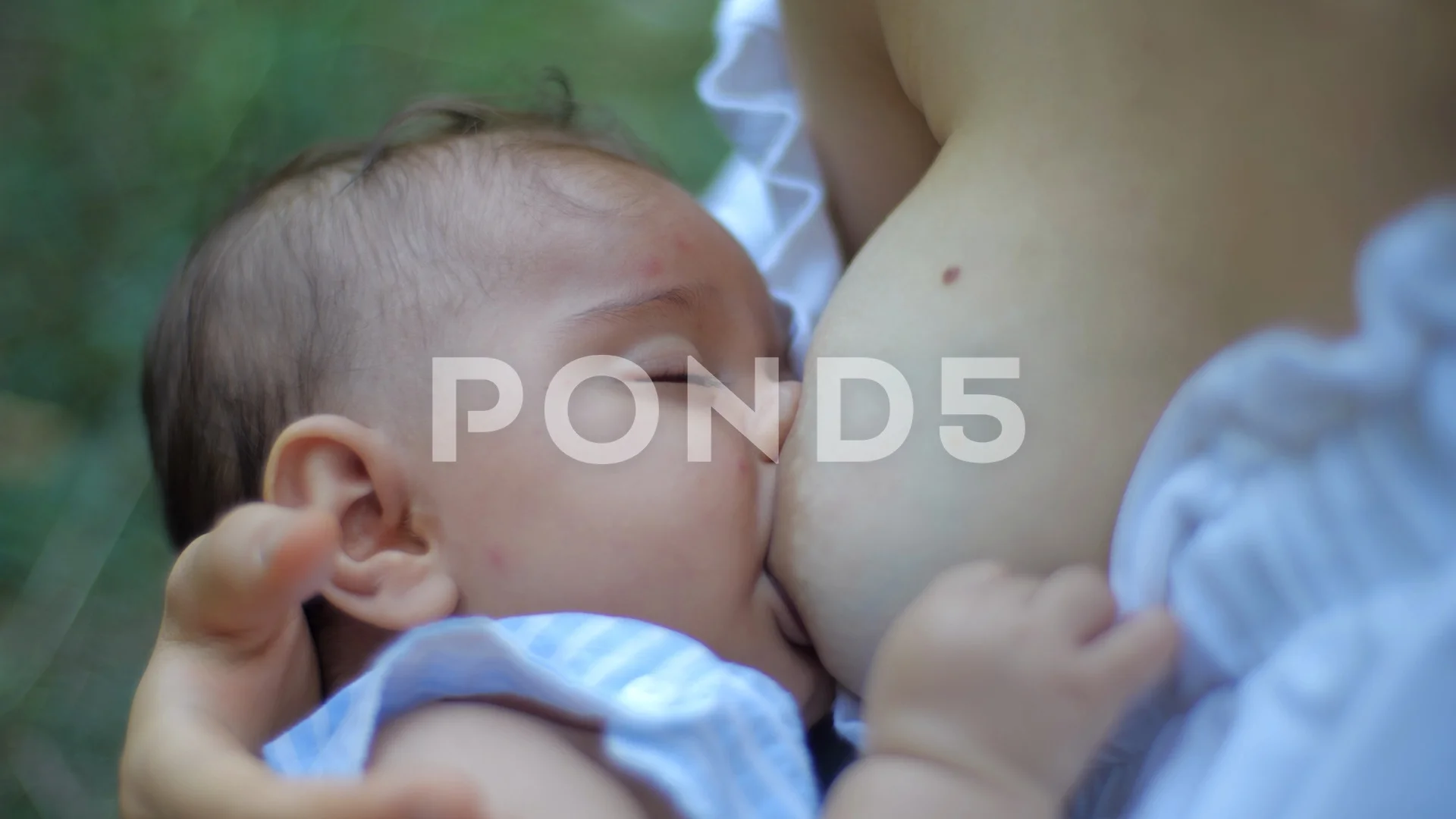 Young beautiful mother, breastfeeding he... | Stock Video | Pond5