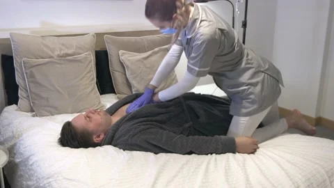 Young beautiful nurse doing artificial respiration with her hands on the Stock Footage 225648976