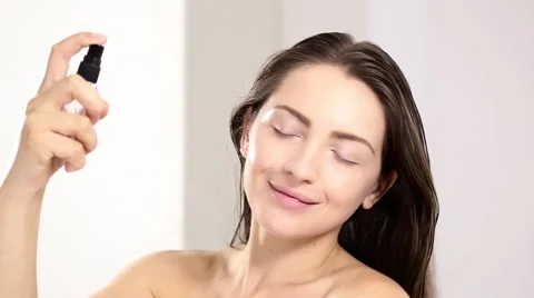 Young beautiful perfect model applying spay water on the face Stock Footage 65213473