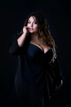 Young beautiful plus size model in underwear, xxl woman on black Photos